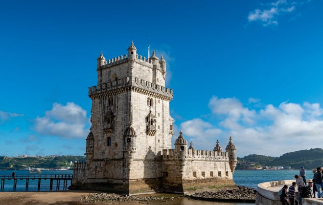 white concrete building near body of water